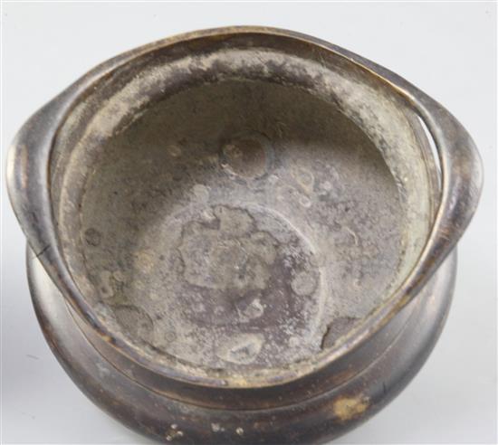 A Chinese bronze ding censer and stand, width 15.5cm